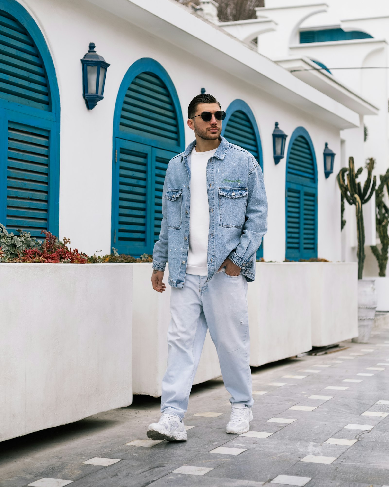 A man in a denim jacket over a white shirt
