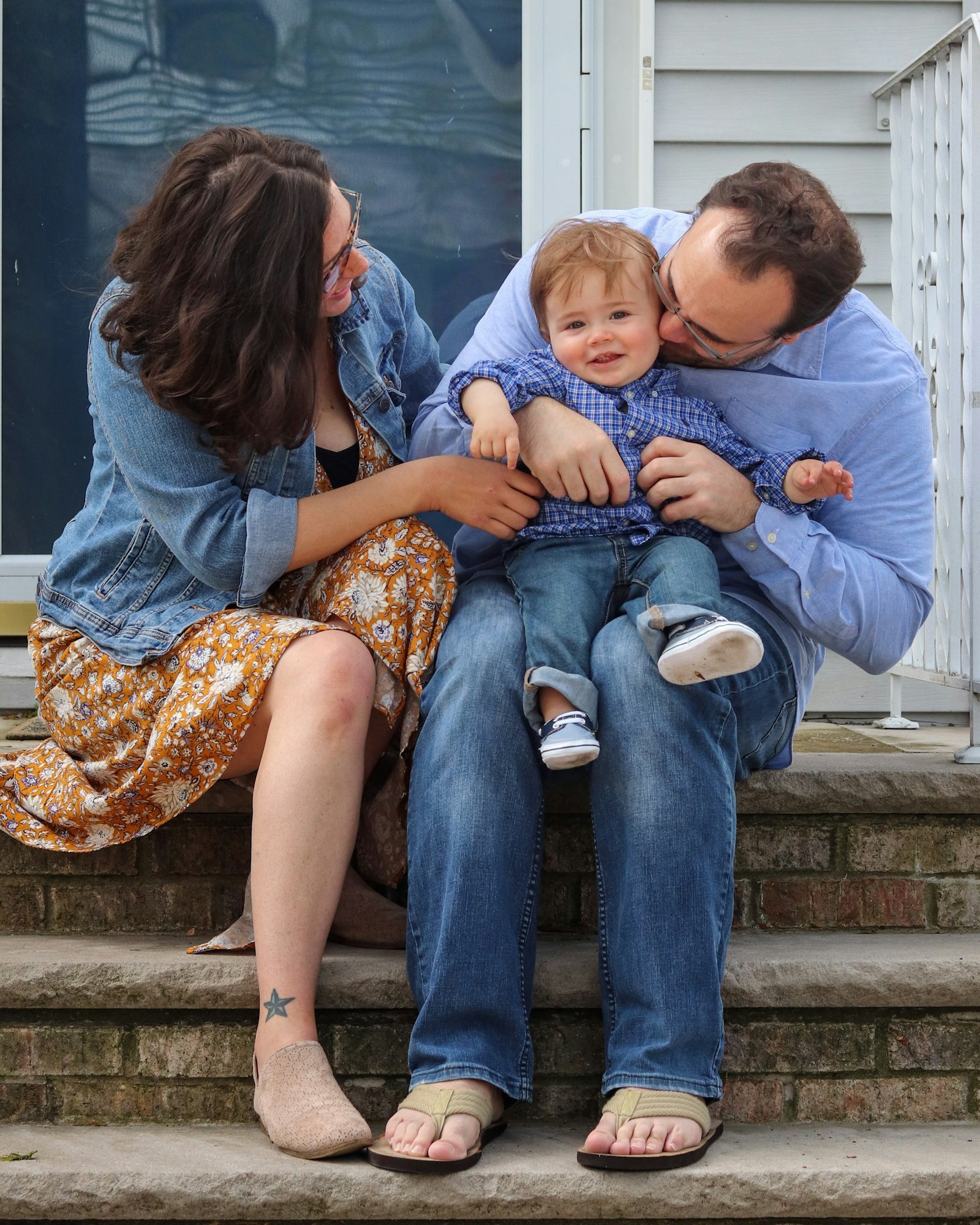 A couple sitting together, both dressed in blue denim