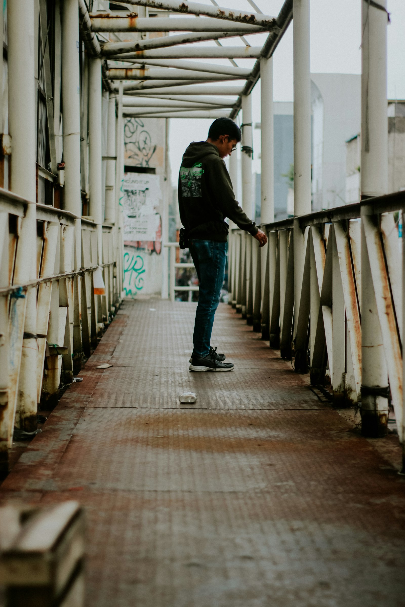 A man in a jacket and blue denim jeans